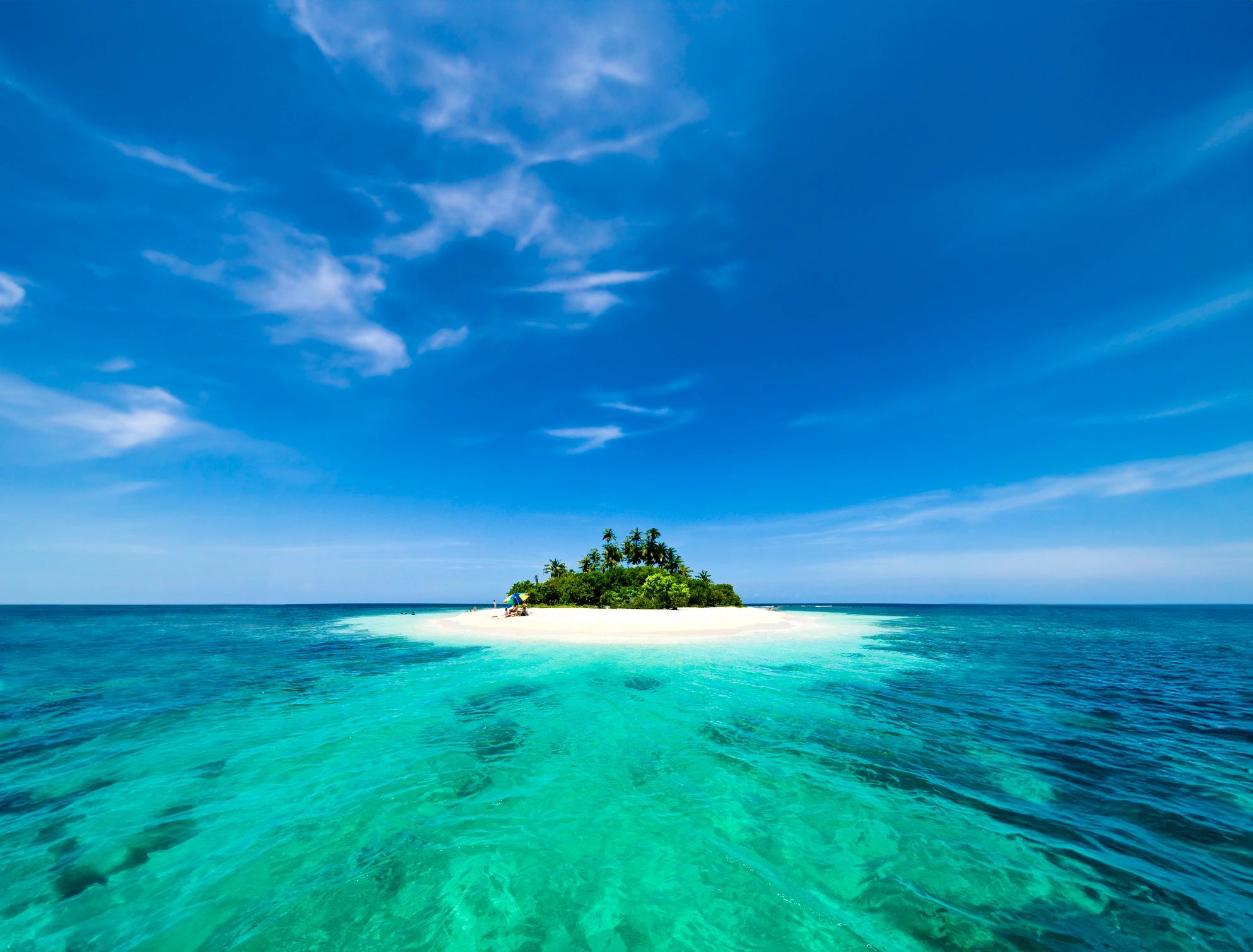 Remote white sand tropical island with palm trees