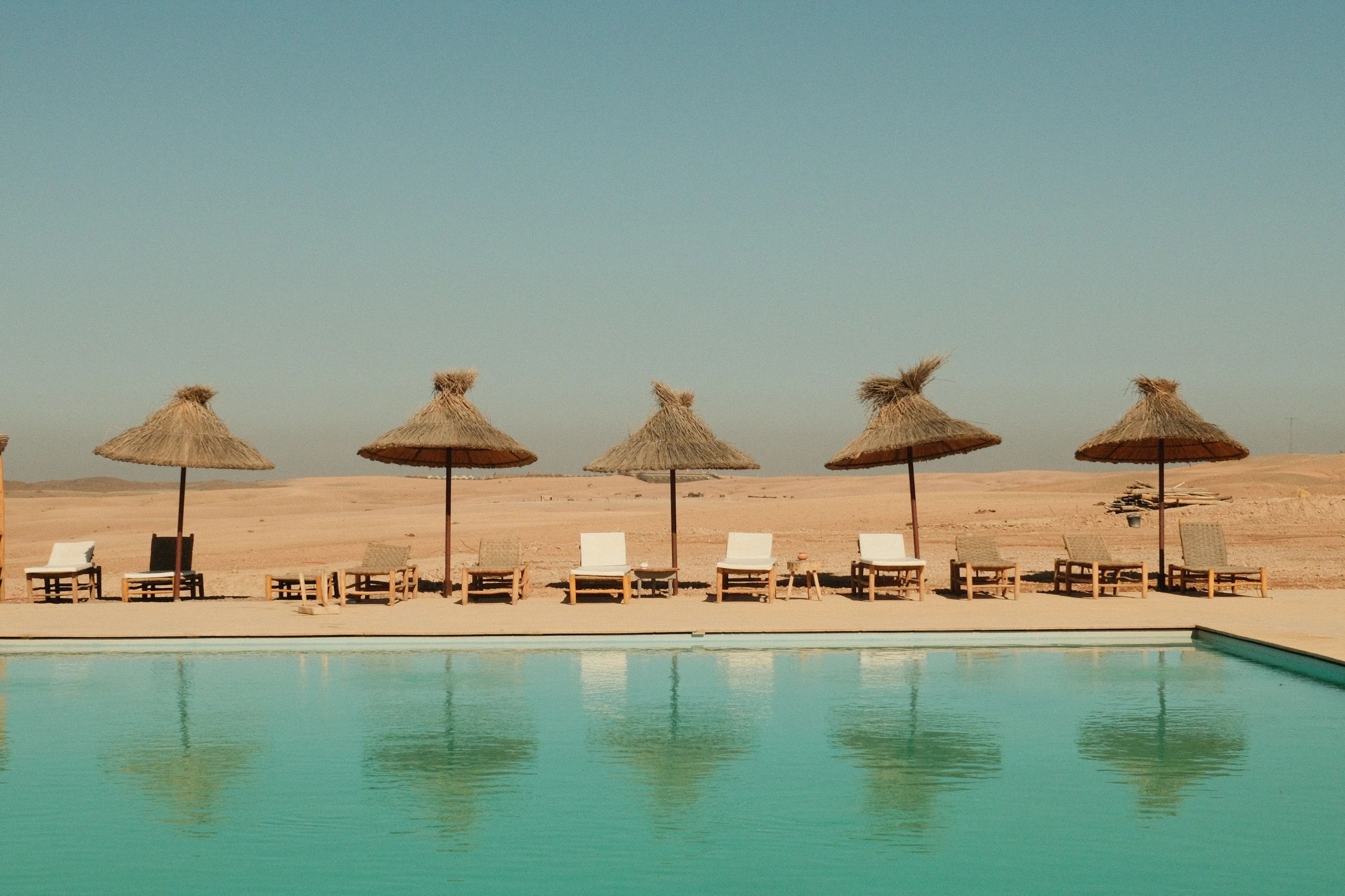 Luxury desert resort pool evoking safari lodge escape