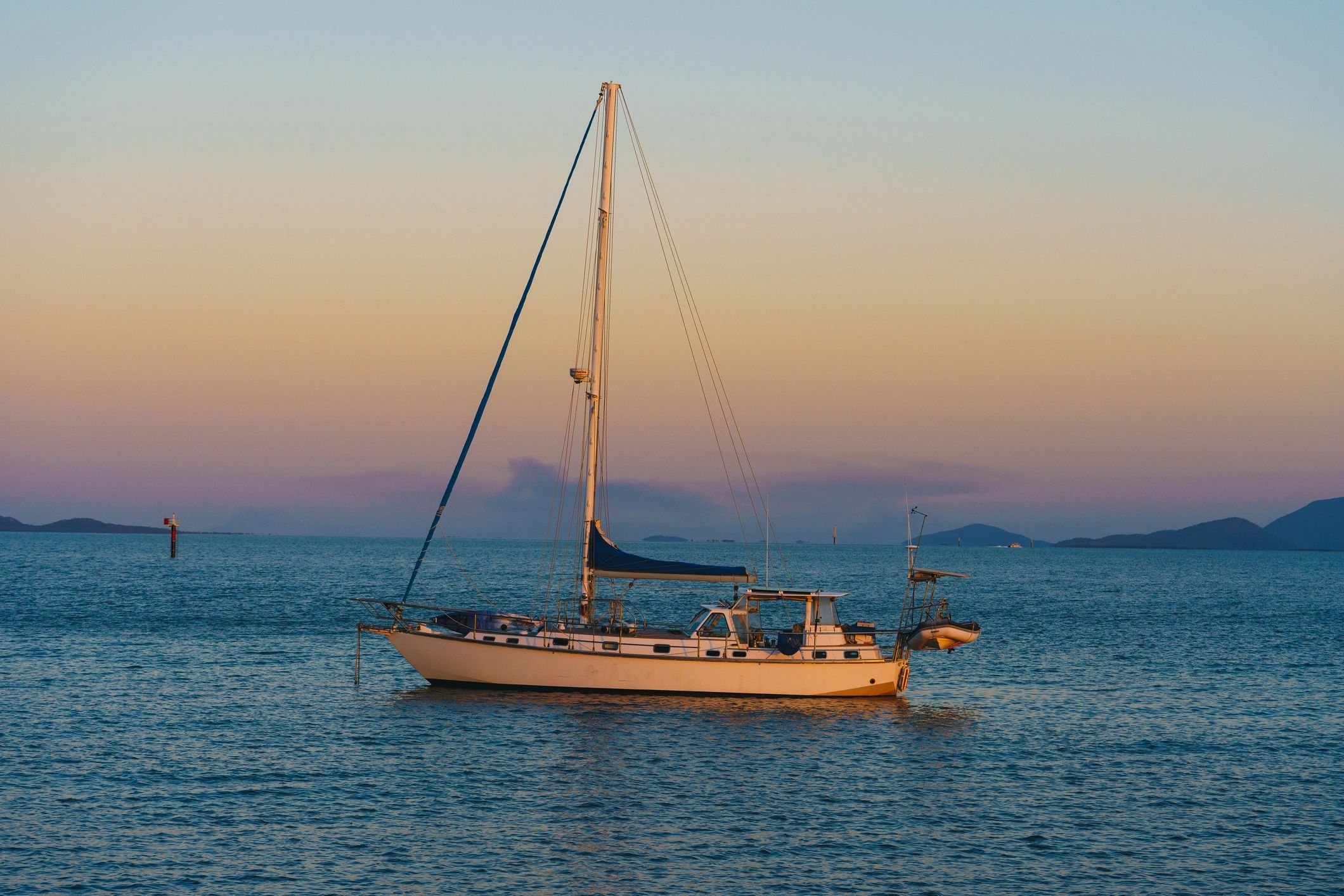 Sailboat moored at sea during golden hour