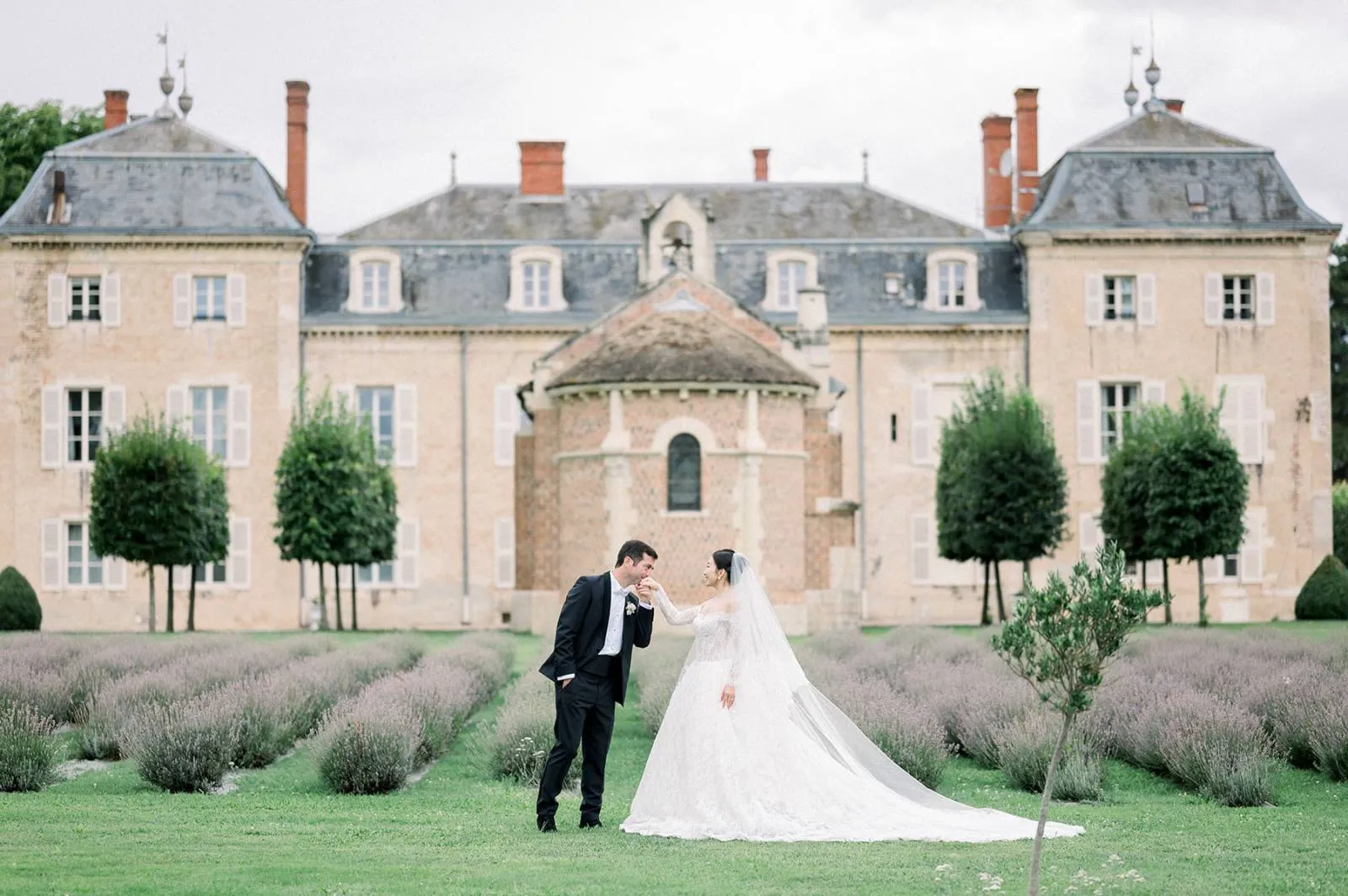Bride and groom in front of chateau