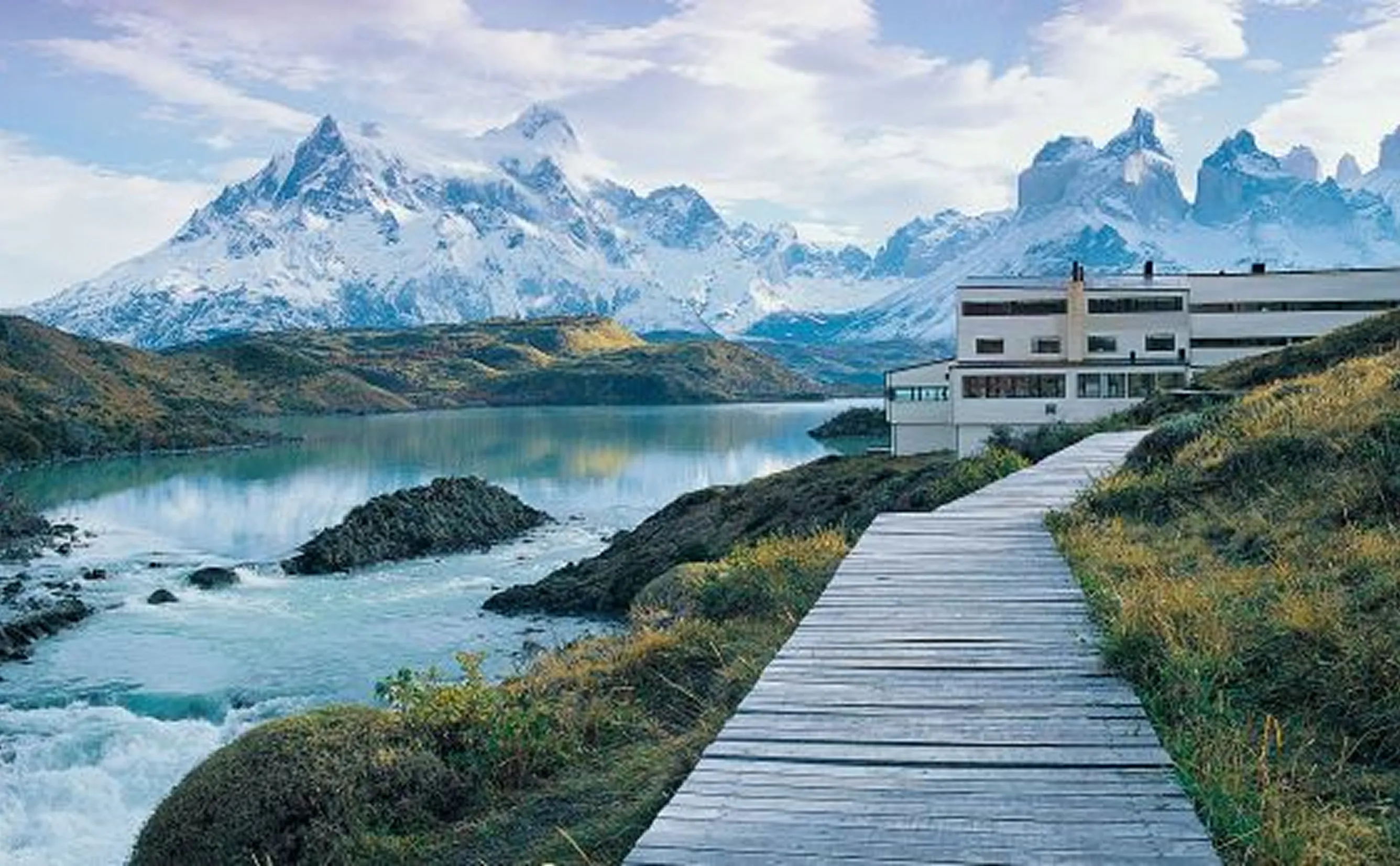Boardwalk leading to lodge by mountain lake