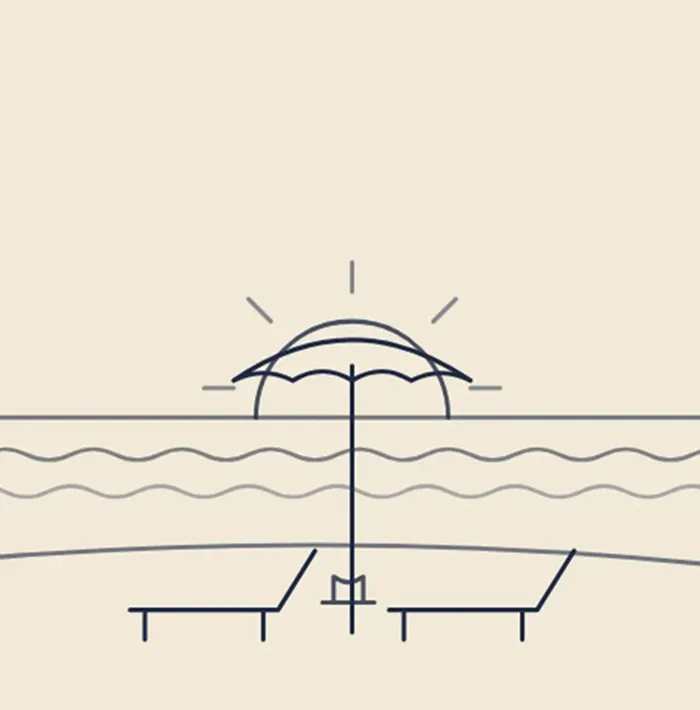 Beach umbrella and two lounge chairs by ocean